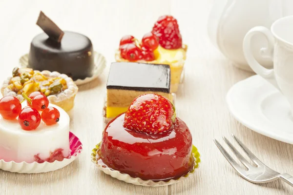 Different sort of beautiful pastry, small colorful sweet cakes — Stock Photo, Image