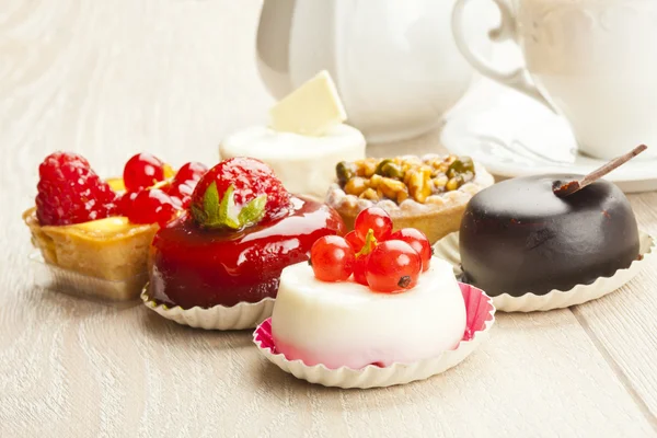 Different sort of beautiful pastry, small colorful sweet cakes — Stock Photo, Image