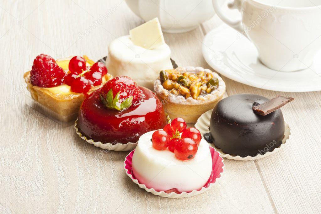 Different sort of beautiful pastry, small colorful sweet cakes