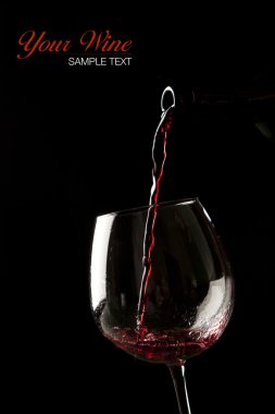 üzerinde siyah arka plan üzerine bir bardak kırmızı şarap splash.