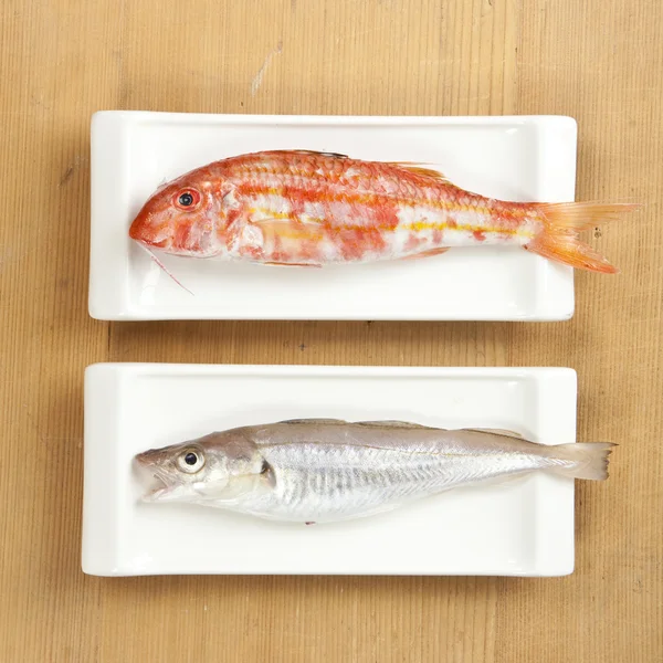 Two fishes on wooden background — Stock Photo, Image