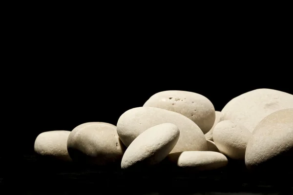 White stones on black background — Stock Photo, Image