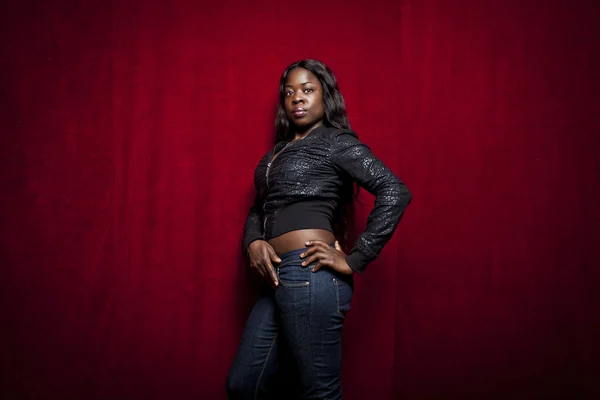 Portrét krásné africké ženy na červeném pozadí — Stock fotografie