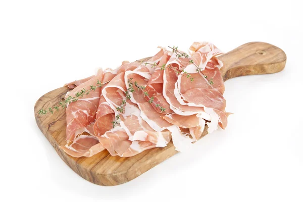Slices of italian raw ham on wooden board — Stock Photo, Image