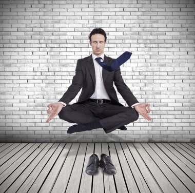 young businessman levitating in yoga position, meditation