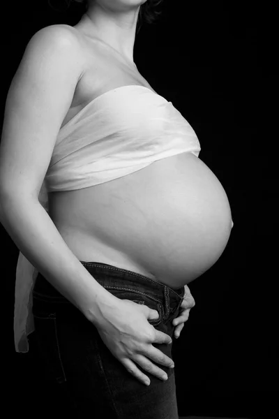 Pregnant woman's belly on black background — Stock Photo, Image