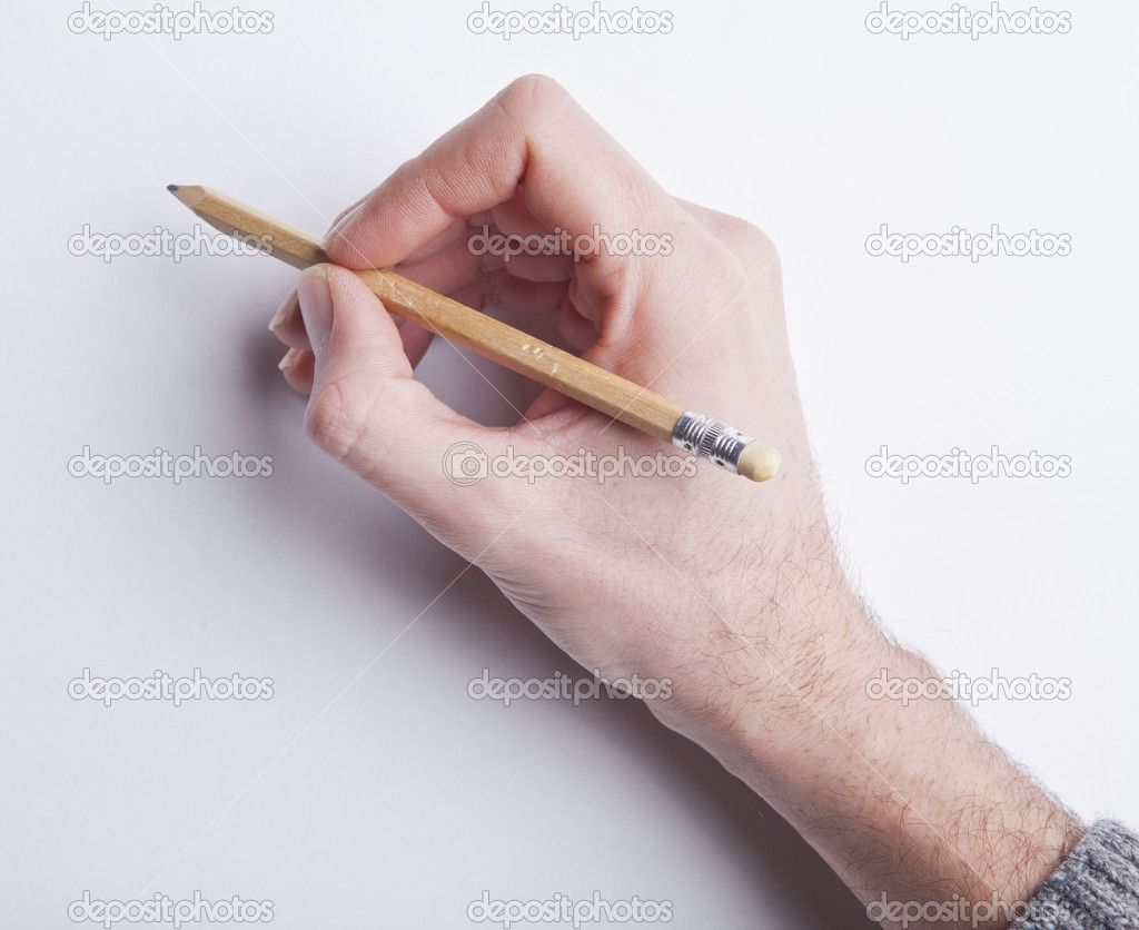 male's hand holding pancil writing on blank white paper