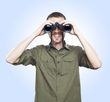young man looking with binoculars, cheerful face expression
