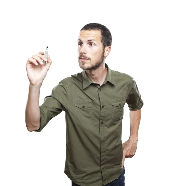 Joven hombre casual escribiendo algo en tablero de cristal con marcador — Foto de Stock