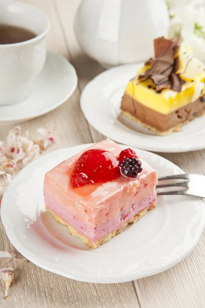 Mooie gebak, beetje kleurrijke zoete taarten met thee — Stockfoto