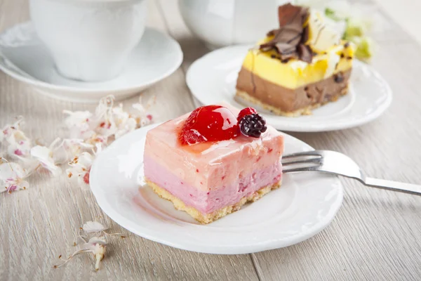 Schönes Gebäck, kleine bunte süße Kuchen mit Tee — Stockfoto