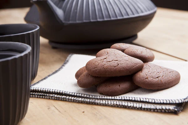 Delicious chocolate heart shape biscuits with tea — Stock Photo, Image