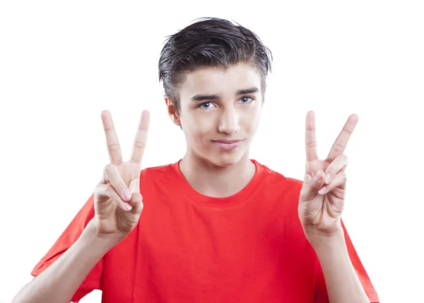 Portrait of handsome young boy showing victory sign on white background — Stock Photo, Image