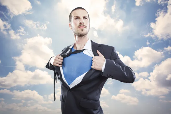 Young businessman acting like a super hero and tearing his shirt off — Stock Photo, Image