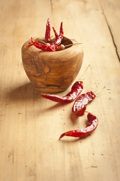 Red hot dry chili peppers over wooden background — Stock Photo, Image