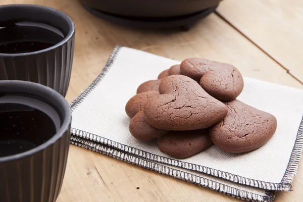 Delicious chocolate heart shape biscuits with tea — Stock Photo, Image