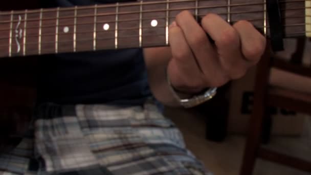 Un joven toca la guitarra . — Vídeo de stock