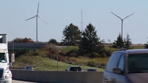 Tráfego passa por turbinas eólicas altas — Vídeo de Stock