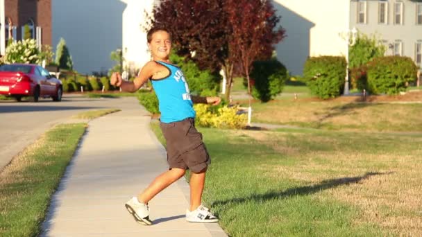 A young boy dances outside. — Stock Video