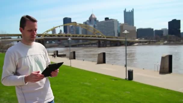 Man Uses iPad Outside — Stock Video