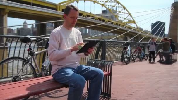 Man Uses iPad Outside — Stock Video