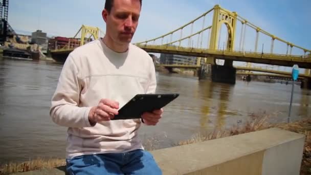 Man Uses iPad Outside — Stock Video