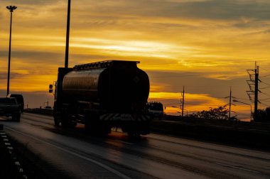 Kargo kamyonu yazın gün batımında karayolunda gidiyor.