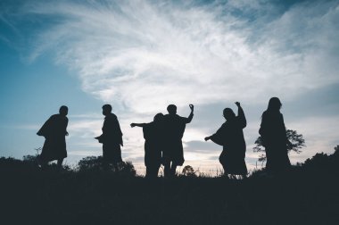 Group of teamwork people jump freedom happy playing at summer sunset in nature