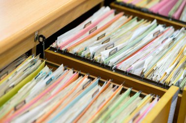 Important financial and investment documents are stored in filing cabinets at the office.