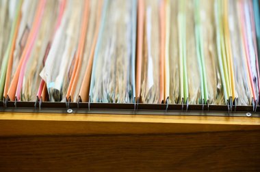 Important financial and investment documents are stored in filing cabinets at the office.