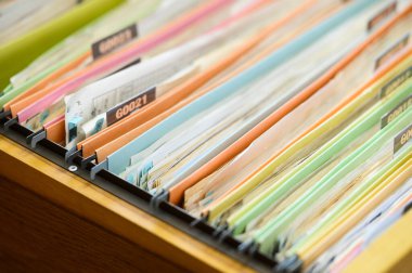 Important financial and investment documents are stored in filing cabinets at the office.