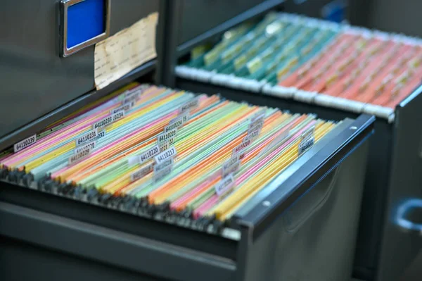 Important financial and investment documents are stored in filing cabinets at the office.