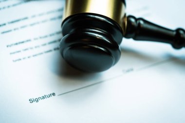 Ahşap yargıç tokmağı ile imzalı sözleşme belgesi