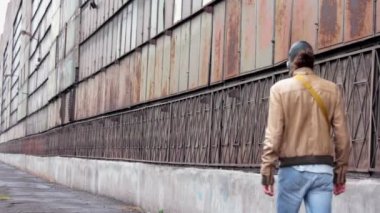 Gaz Maskeli adam tozlu fabrika duvar boyunca gider