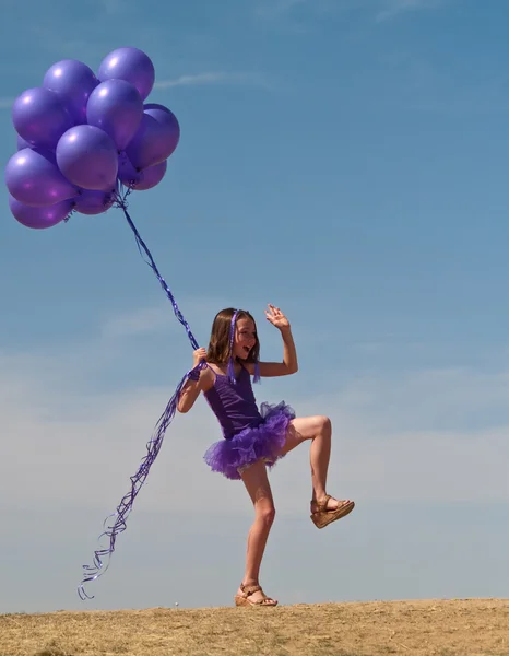 Pretty little girl with baloons in hand — Stock Photo, Image