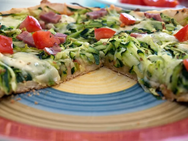 Pizza with zucchini and mozzarella on plate