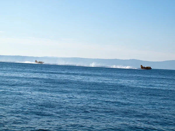 Two fire fighter airplane landing at sea — Stock Photo, Image