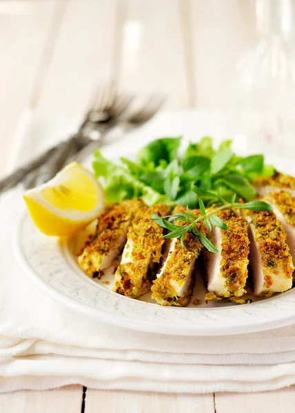 Sliced lemon herb crusted chicken breast, copy space for your text — Stock Photo, Image