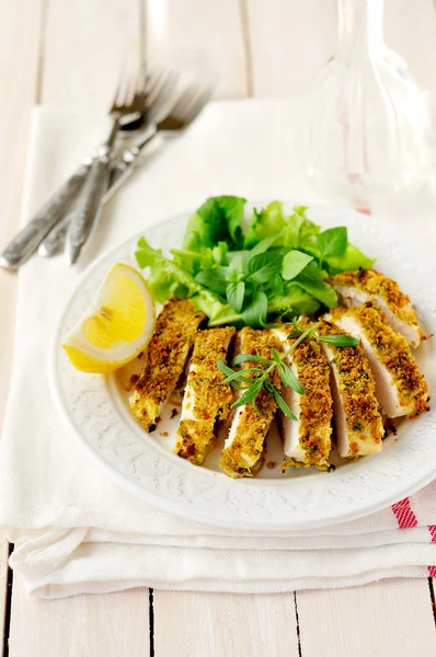 Sliced lemon herb crusted chicken breast, copy space for your text — Stock Photo, Image