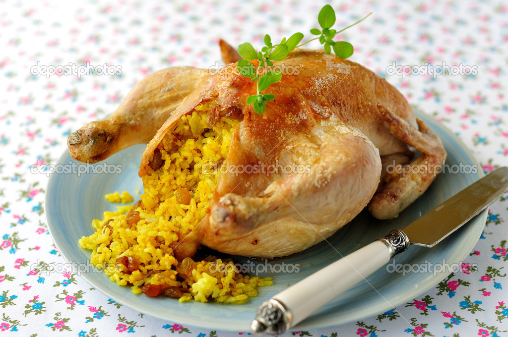 Whole Roast Chicken Stuffed with Curried Rice and Sultanas, selective focus