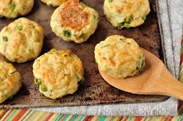 Baked potato patties with turkey, cheese and peas — Stock Photo, Image