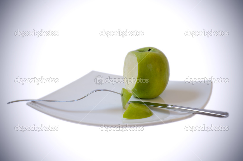 Sliced apple with knife and fork