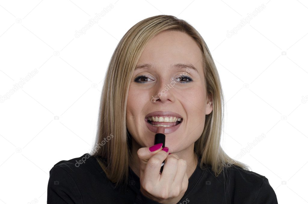 Young woman using lipstick on white background