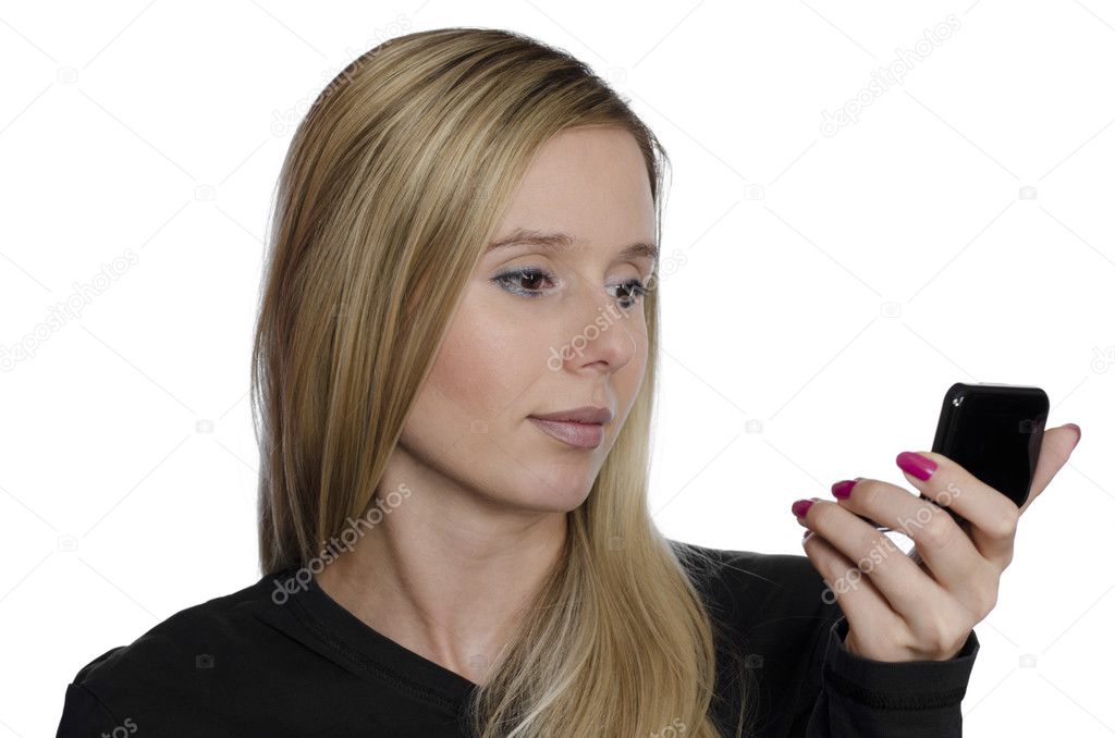 Young woman looking at her self in small mirror on white background