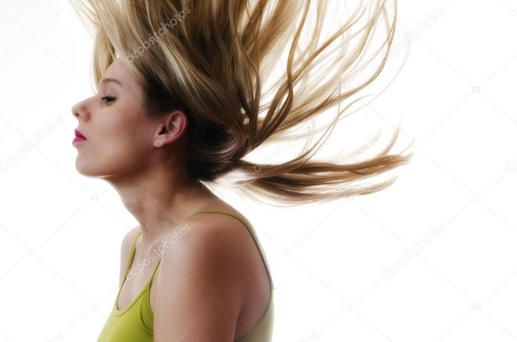 woman with hair flying in the air on white background