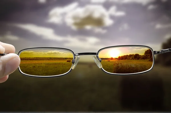 Seeing sunset through glasses — Stock Photo, Image
