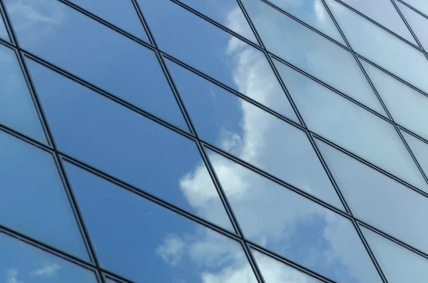 Superficie de vidrio de un edificio con reflejo de una nube — Foto de Stock
