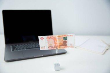 Russian money five thousand dollar bills on a laptop