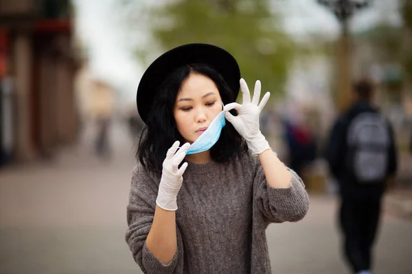 the woman removes the medical mask. Pandemic safety. Covid-19