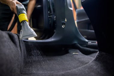 Dry cleaning of car interior with vacuum cleaner. car dry cleaning